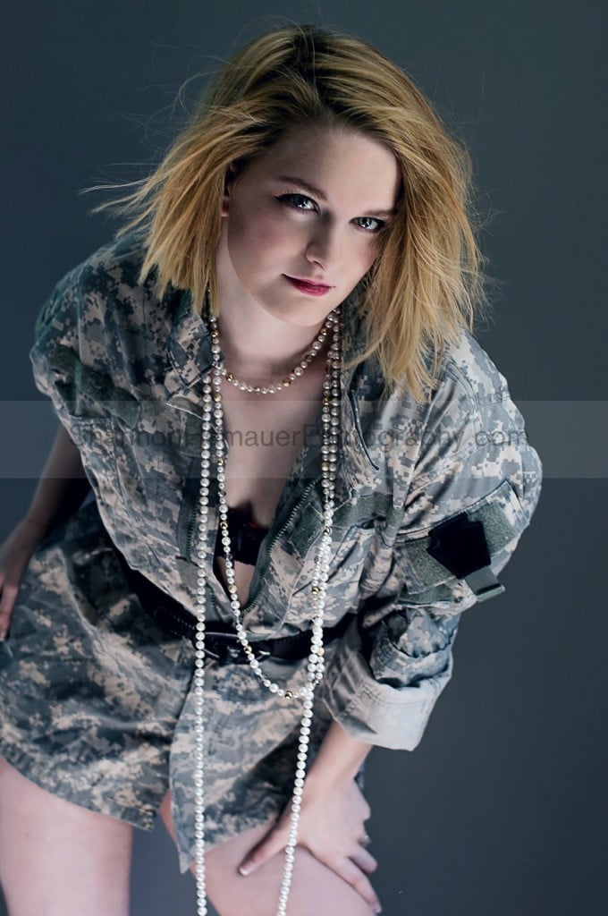 Woman wearing camo and pearls for boudoir.