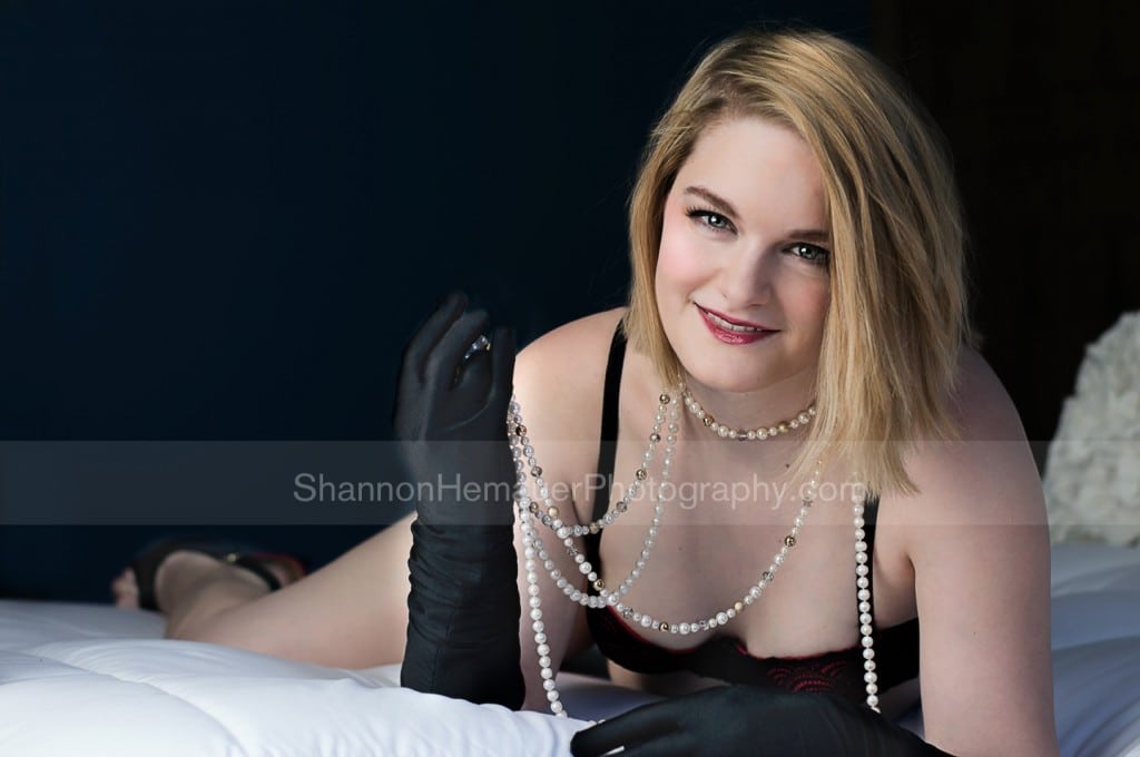 Woman wearing pearl necklace for boudoir.