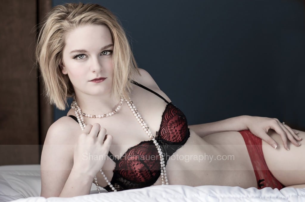 Woman wearing red bra and panties for boudoir.