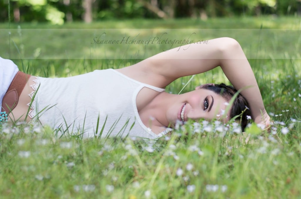 Girl laying in field of flowers