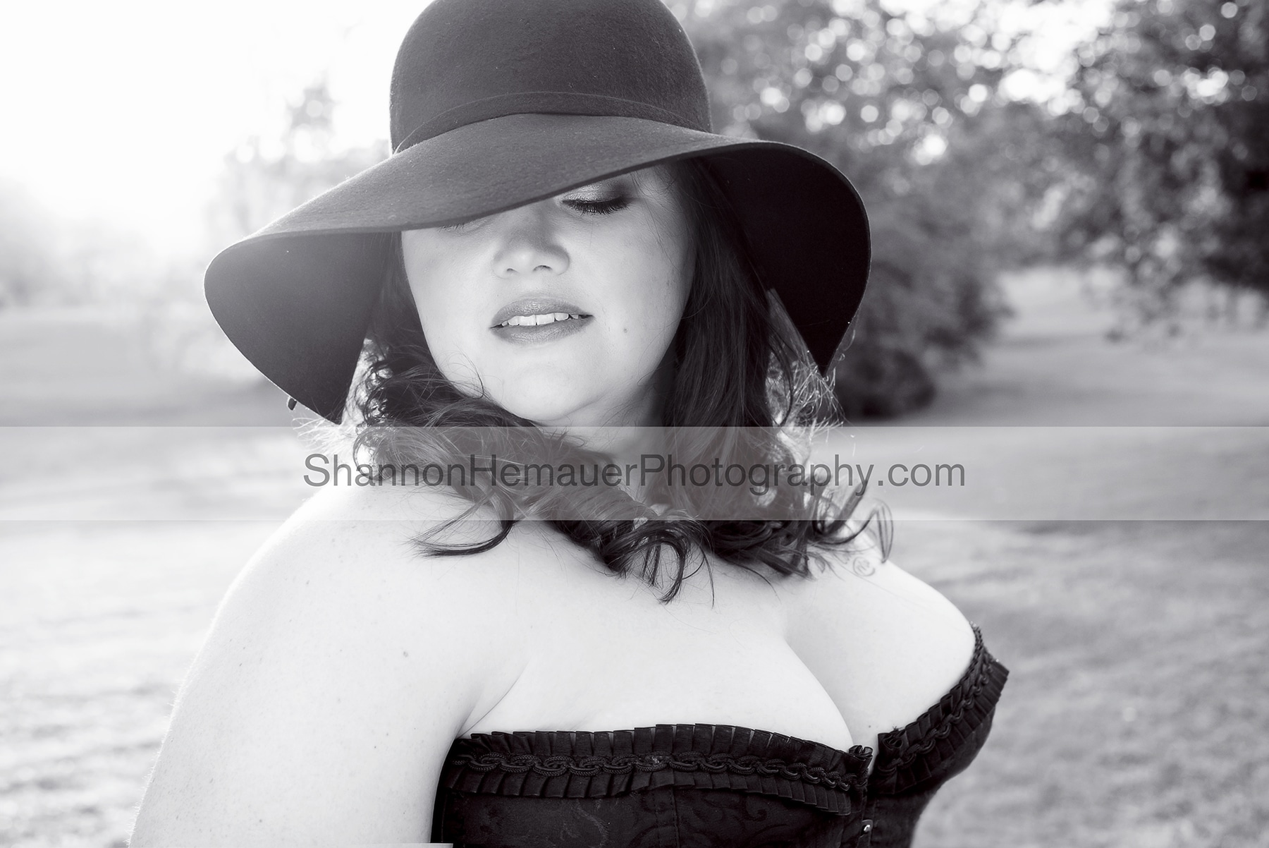 Wearing a big, floppy black hat for a glamour sunset session